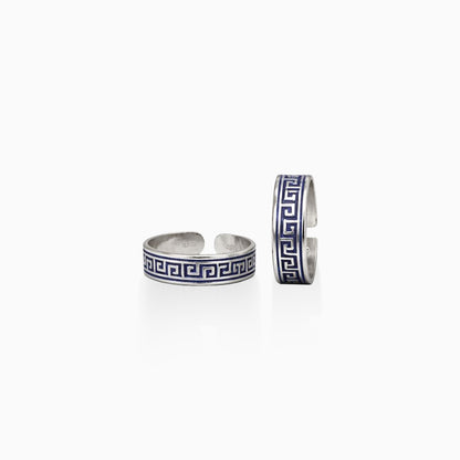 Two silver cuff bracelets with blue and white pattern on a white background