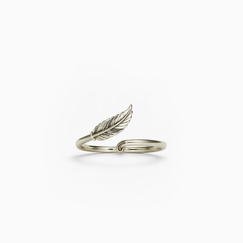 Silver feather-shaped ring on a white background