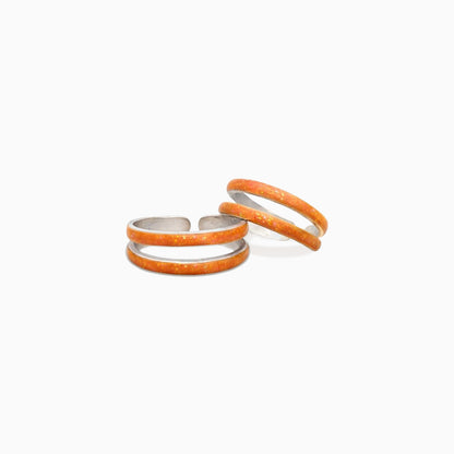 Three orange rings stacked on a white background