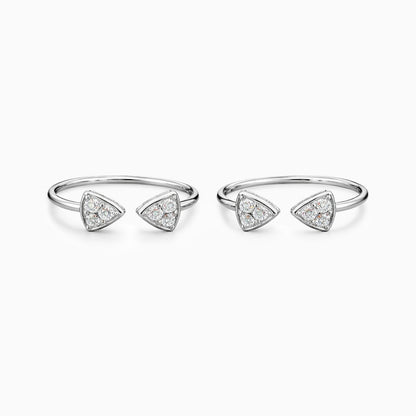 Set of four silver rings with triangle-shaped diamond accents on a white background