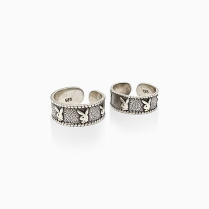 Two silver open rings with rabbit designs on a white background