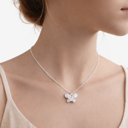 Butterfly necklace on a model with a plain background