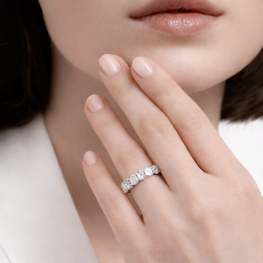 Close-up of a hand wearing a diamond ring with a blurred background