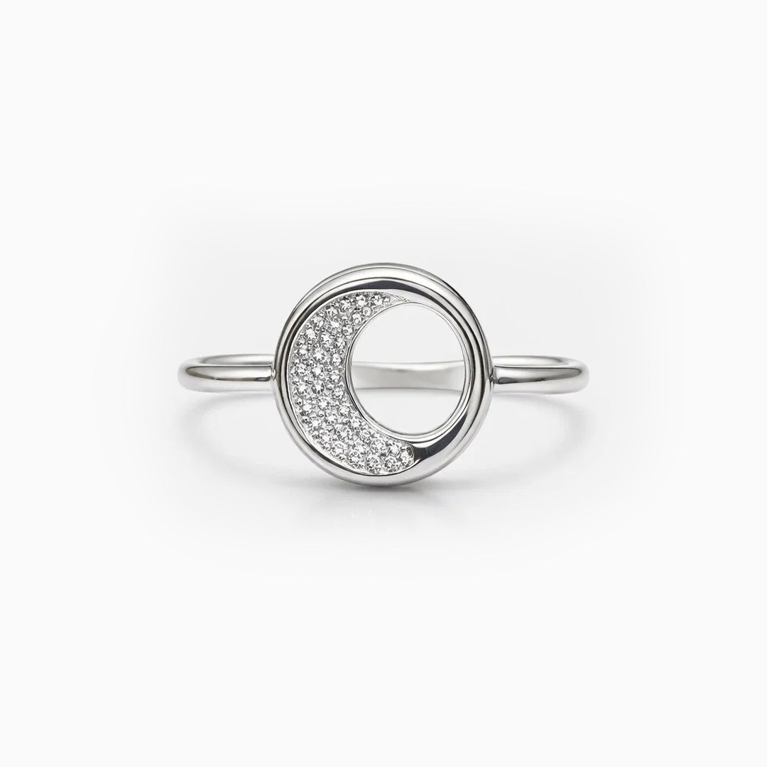 Silver ring with a crescent moon design on a white background