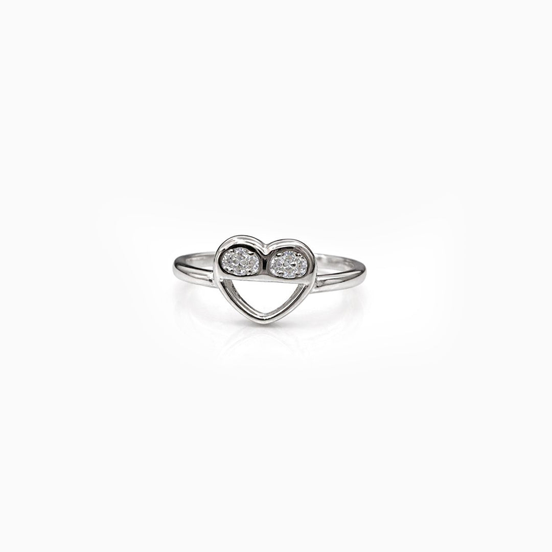 Heart-shaped ring with two diamonds on a white background
