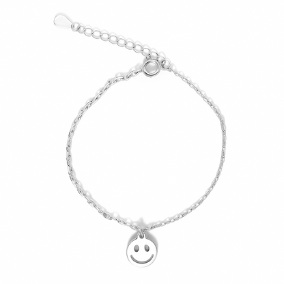 Silver bracelet with a smiley face charm on a white background.