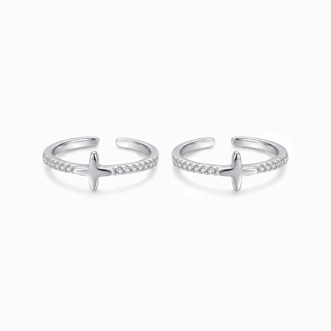 Pair of silver open rings with star designs on a white background