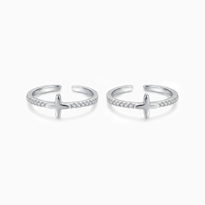 Pair of silver open rings with star designs on a white background