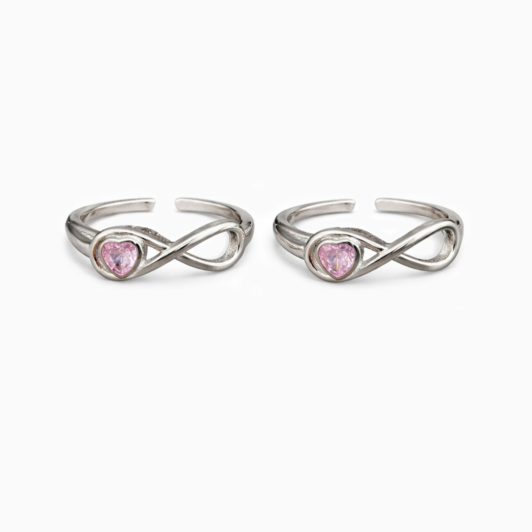 Two silver rings with pink gemstones on a white background