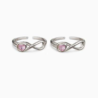 Two silver rings with pink gemstones on a white background