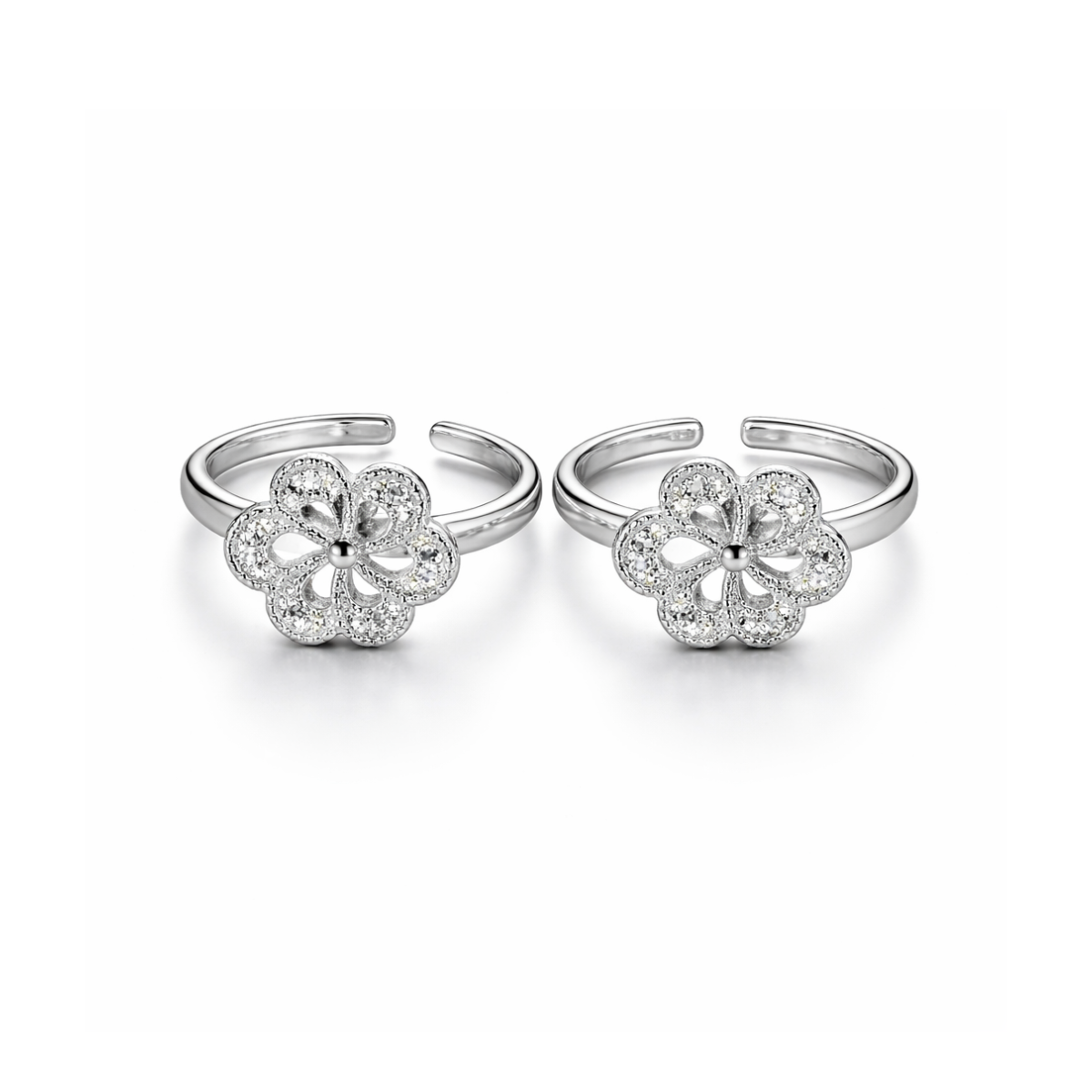 Pair of silver flower-shaped open toe rings on a white background