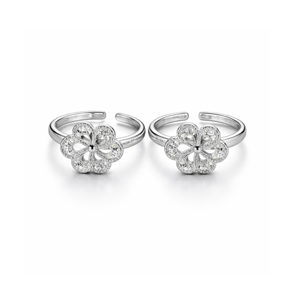 Pair of silver flower-shaped open toe rings on a white background