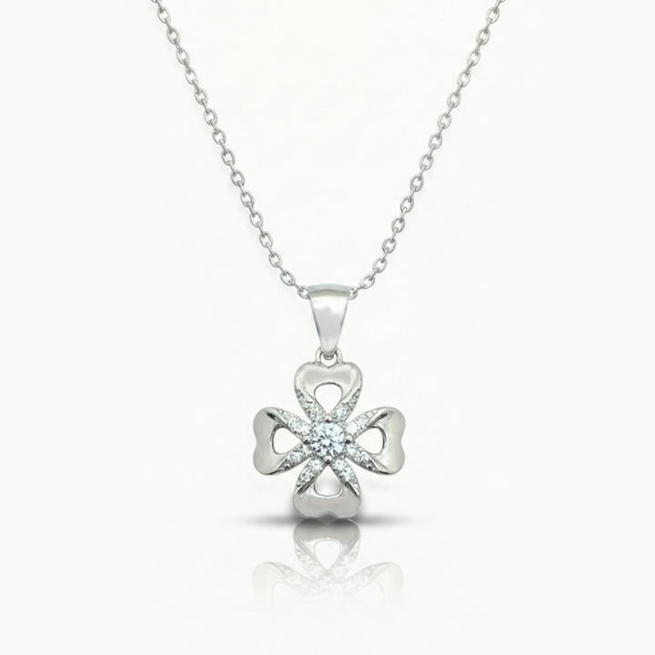 Silver four-leaf clover pendant necklace on a white background