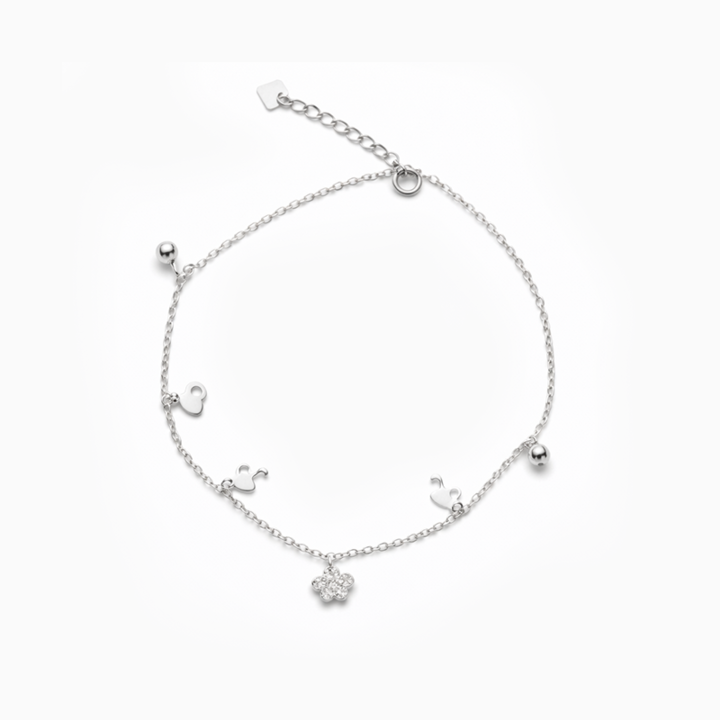 Silver bracelet with small charms on a white background