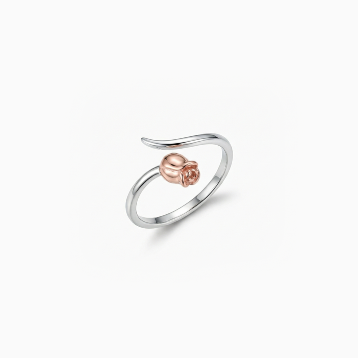 Silver ring with a rose gold heart on a white background
