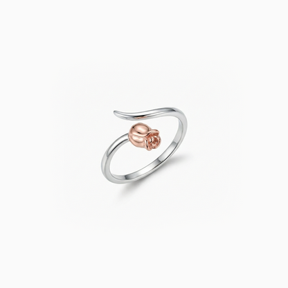 Silver ring with a rose gold heart on a white background