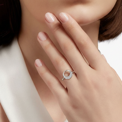 Close-up of a hand wearing a silver ring with a white background