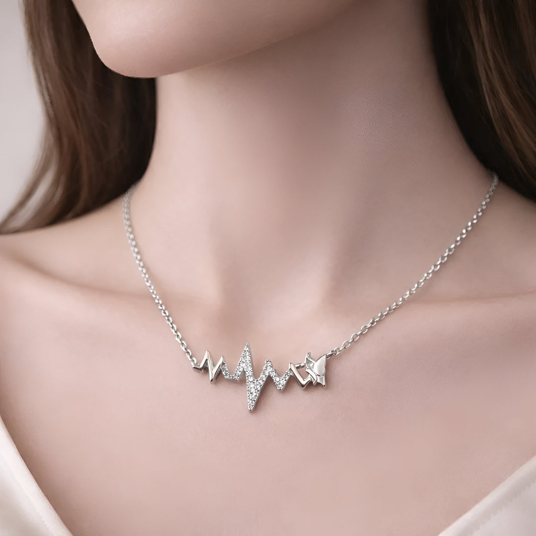 Silver necklace with heart and star pendants on a mannequin