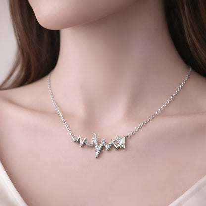 Silver necklace with heart and star pendants on a mannequin