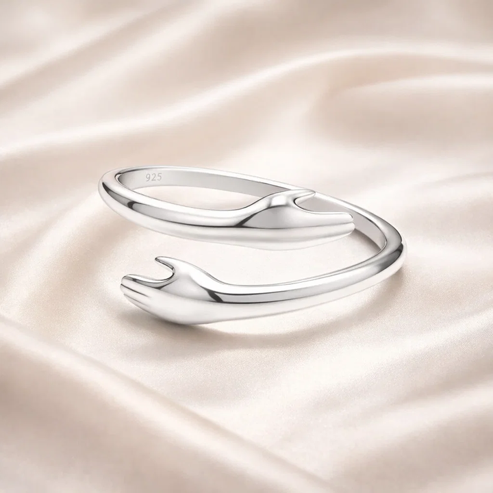Silver ring on a satin surface
