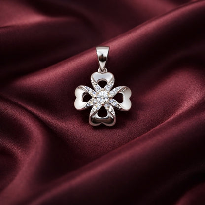 Silver four-leaf clover pendant on a burgundy satin background